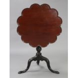 An 18th century mahogany tripod table with a lobed circular top & birdcage support, on turned &