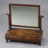 A Victorian mahogany swing toilet glass with rectangular mirror on foliate-carved supports, fitted