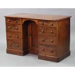 An early Victorian mahogany kneehole desk, with rounded corners & moulded edge to the rectangular