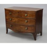An early 19th century mahogany low bow-front chest, fitted two short & two long drawers with brass