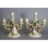 A pair of Meissen floral-encrusted three-branch candelabra, each with dancing girl & fiddle-