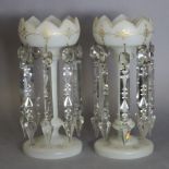 A pair of Victorian clear & frosted glass candle lustres with gilt decoration & hung with prism