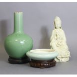 A blanc-de-chine seated figure of Guanyin on lotus base, 10¼” high; a green-glazed crackleware