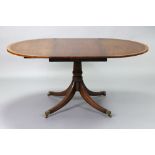 A regency-style mahogany extending dining table with crossbanded circular top, fitted two additional