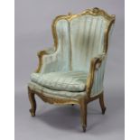 A Louis XVI style carved giltwood frame bergere, the padded back, sides & loose cushion seat