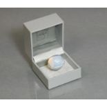 A Lalique opalescent glass finger ring of round domed design, engraved mark “Lalique, France”,
