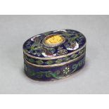 A Chinese enamelled metal oval box & cover, inset carved tiger’s-eye floral cabochon, & with all-