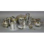 A Victorian silver-plated round teapot & matching milk jug with engraved scroll decoration; a pair