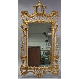 A 20th century Chinese Chippendale-style rectangular wall mirror in carved & pierced giltwood frame,