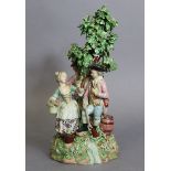 An 18th century Derby porcelain figure group depicting three figures standing around the base of a