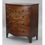 An early 19th century figured mahogany bow-front chest, fitted two short & three long drawers with