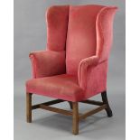 A beech-frame Georgian-style wing-back armchair, upholstered light red velour, on square legs