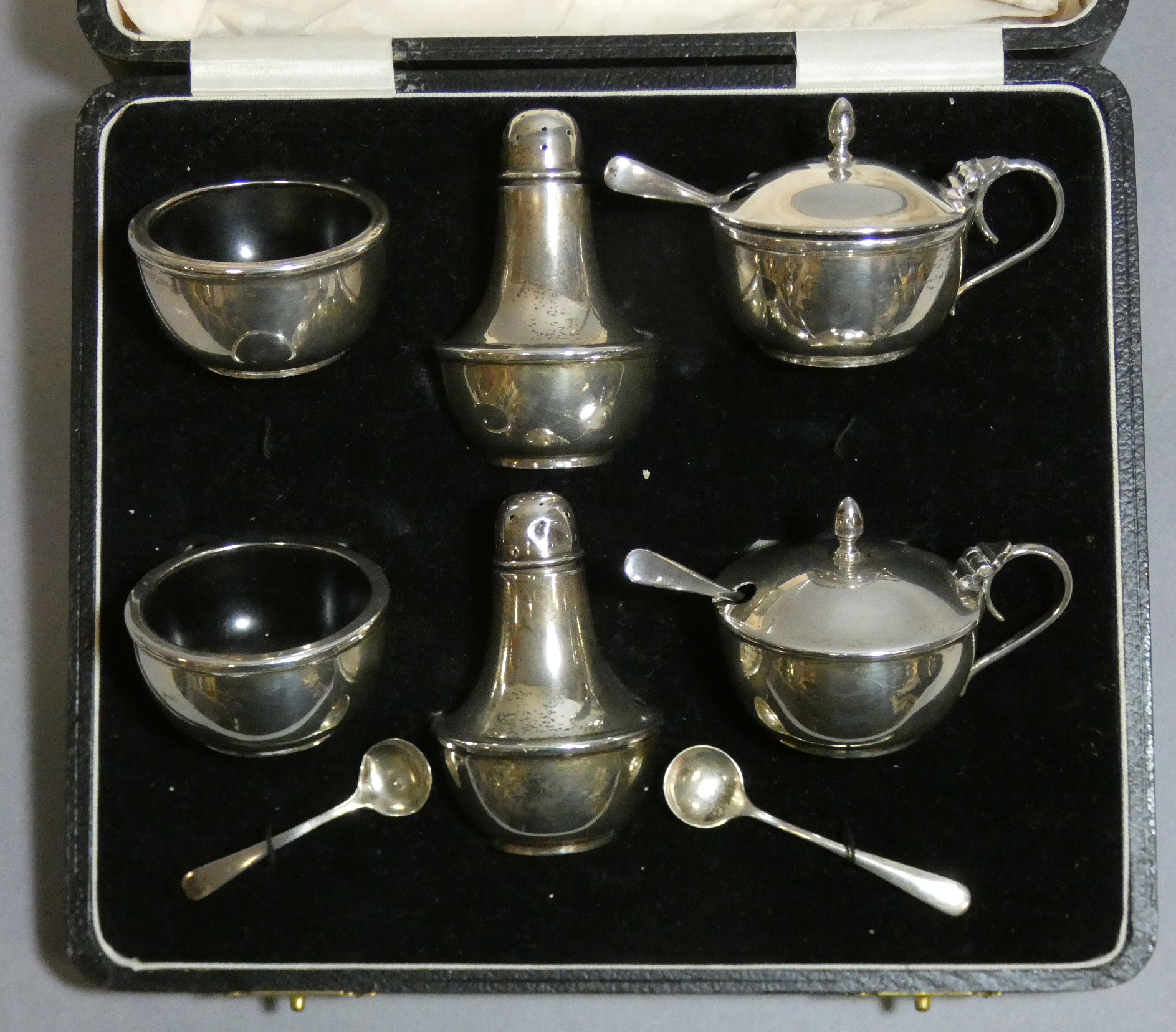 A George V silver condiment set of compressed round form, comprising a pair of mustard pots with