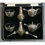 A George V silver condiment set of compressed round form, comprising a pair of mustard pots with