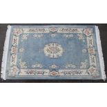 A 20th century Chinese wool carpet, of pale blue ground with a central medallion surrounded by