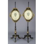 A PAIR OF MID-VICTORIAN EBONISED & PARCEL-GILT POLE BANNER SCREENS, inset silk needlework panels