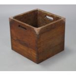 An oak rectangular log box with pierced side handles and planished copper mounted corners, 13¼” wide