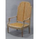 A French carved & painted frame large elbow chair with tall caned back & seat, on turned & fluted