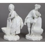 A pair of 19th century continental white-glazed porcelain standing male & female figures in 18th