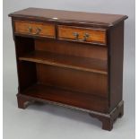 A reproduction inlaid-mahogany small standing bookcase fitted two frieze drawers above an open