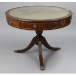 A regency-style mahogany drum-top centre table inset gilt-tooled green leather, fitted four frieze