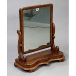 A late 19th century mahogany rectangular swing toilet glass, with scroll-shaped end supports & on