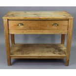 A 19th century pine kitchen table fitted with a frieze drawer, & on square tapered legs with an open