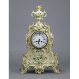 A 19th century French mantel clock with blue painted roman numerals to the white enamel dial, with