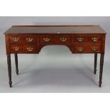 A 19th century mahogany kneehole dressing table fitted with an arrangement of five drawers with