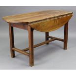 A French cherry or fruitwood oval drop-leaf kitchen table fitted with an end drawer, on square chamf