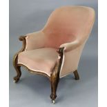 A Victorian tub-shaped easy chair with a sprung seat upholstered pink velour, & on short carved