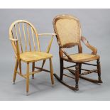 A beech-frame rocking occasional chair, inset woven-cane panel to the seat & back, & with turned