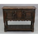 A 17th century-style oak livery cupboard enclosed by a pair of carved panel doors to either side,