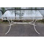 A white painted wrought-iron garden table inset tempered-glass plate to the rectangular top, with