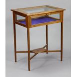 An Edwardian inlaid-mahogany bijouterie table, enclosed by glazed hinged lift-lid & glazed