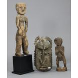 An African carved wood female figure mounted on plinth base, 30” high (over-all); a similar male