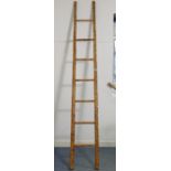 A vintage bamboo seven-rung ladder, 8’ high.