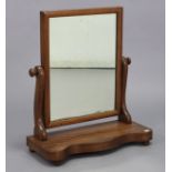 A Victorian mahogany rectangular swing toilet glass on scroll supports, & on serpentine-front