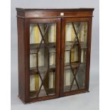 An Edwardian inlaid-mahogany bookcase section fitted two shelves enclosed by a pair of glazed