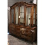 A continental-style tall oak-finish cabinet the upper part fitted with six plate-glass shelves