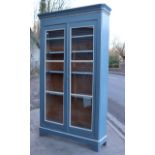 A pale blue & white painted pine tall bookcase with a moulded cornice, having six adjustable shelves