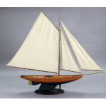 A VICTORIAN-STYLE PAINTED WOODEN POND YACHT, with stails & on wooden stand, 60” long x 48¼” high (