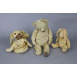 A vintage golden plush teddy bear, 19” tall (worn); a soft toy rabbit, 14½” tall; & a “dog” pyjama