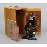 A vintage black lacquered “Kima” monocular microscope by W. Watson & Sons of London (No. 65084),