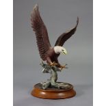 A Franklin Mint porcelain sculpture “Power of the Eagle” by Ronald Van Ruyckevelt, 14” high, with