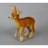 A Steiff reindeer mohair soft toy with button to ear, 13” tall.