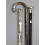 Two gent’s walking canes, each with silver handle; & a simulated bone walking cane.