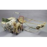 A mid-20th century dog baby walker; a dol’s pram; & a white painted tubular-metal frame see-saw.