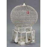 A white painted wirework & wooden birdcage with spherical top, 28” high.