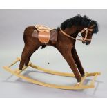 A 1970’s child’s fabric-covered rocking horse, 29” high.